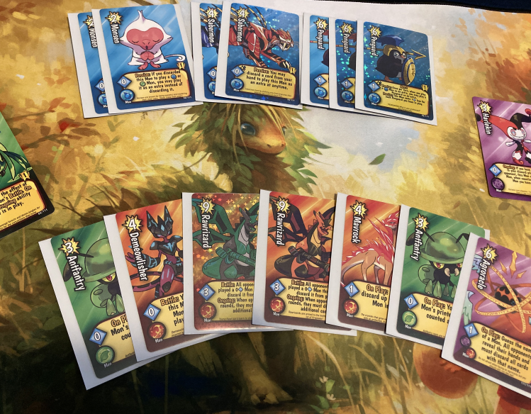 Two decks of Super Battle Mon cards are laid out on a card mat. 